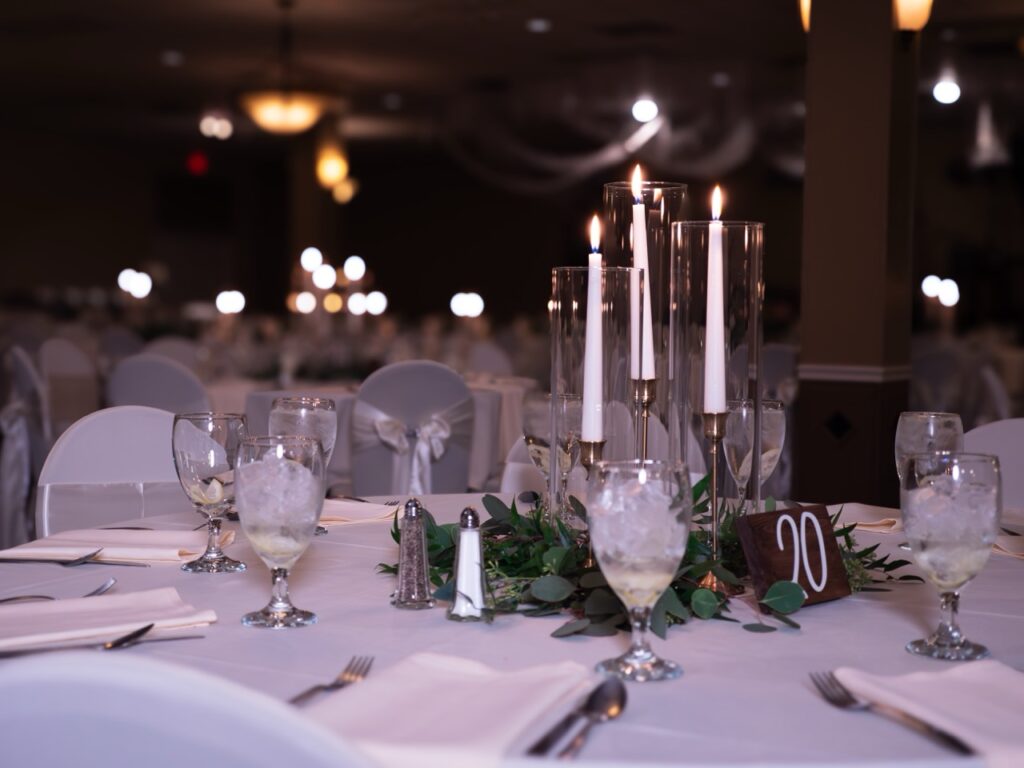 Embassy Event Center in Boardman - Wedding Table Set up with Candles and Greenery